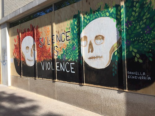 Outside art saying silence is violence