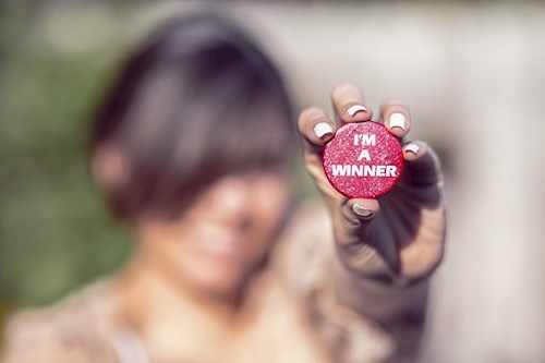 Woman with winner button