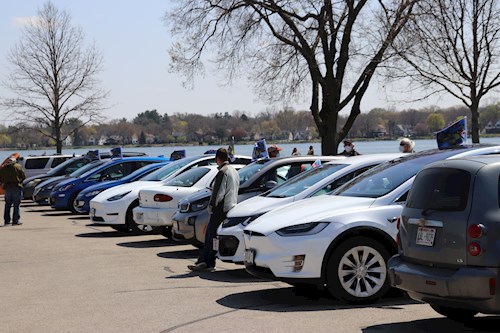 Line of EV cars next to lake