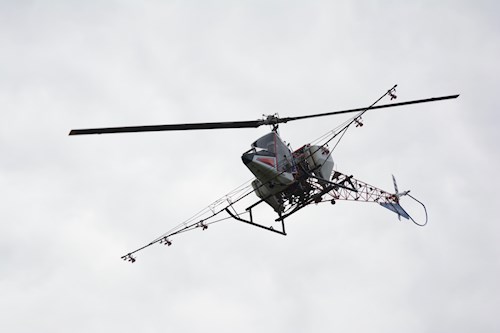 Helicopter with spray nozzles at the bottom flying