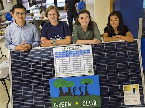 Four students with a solar panel