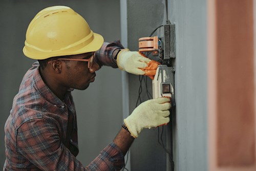 Man in hard hat fixing electrical