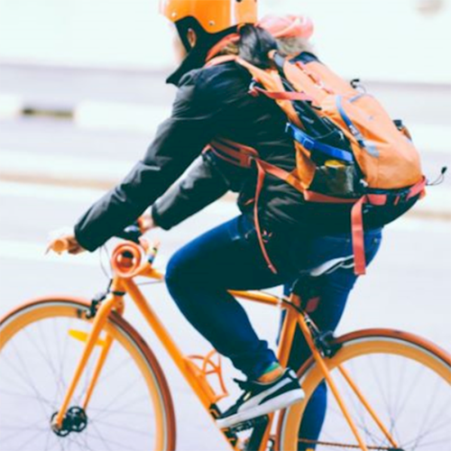Person riding an orange bike