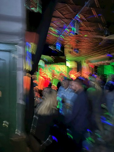 Blurred artistic photo of a bar with multiple people